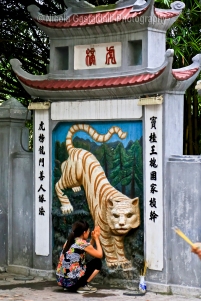 The Temple of the Jade Mountain (Ngoc Son temple ). Woman praying to the tiger.